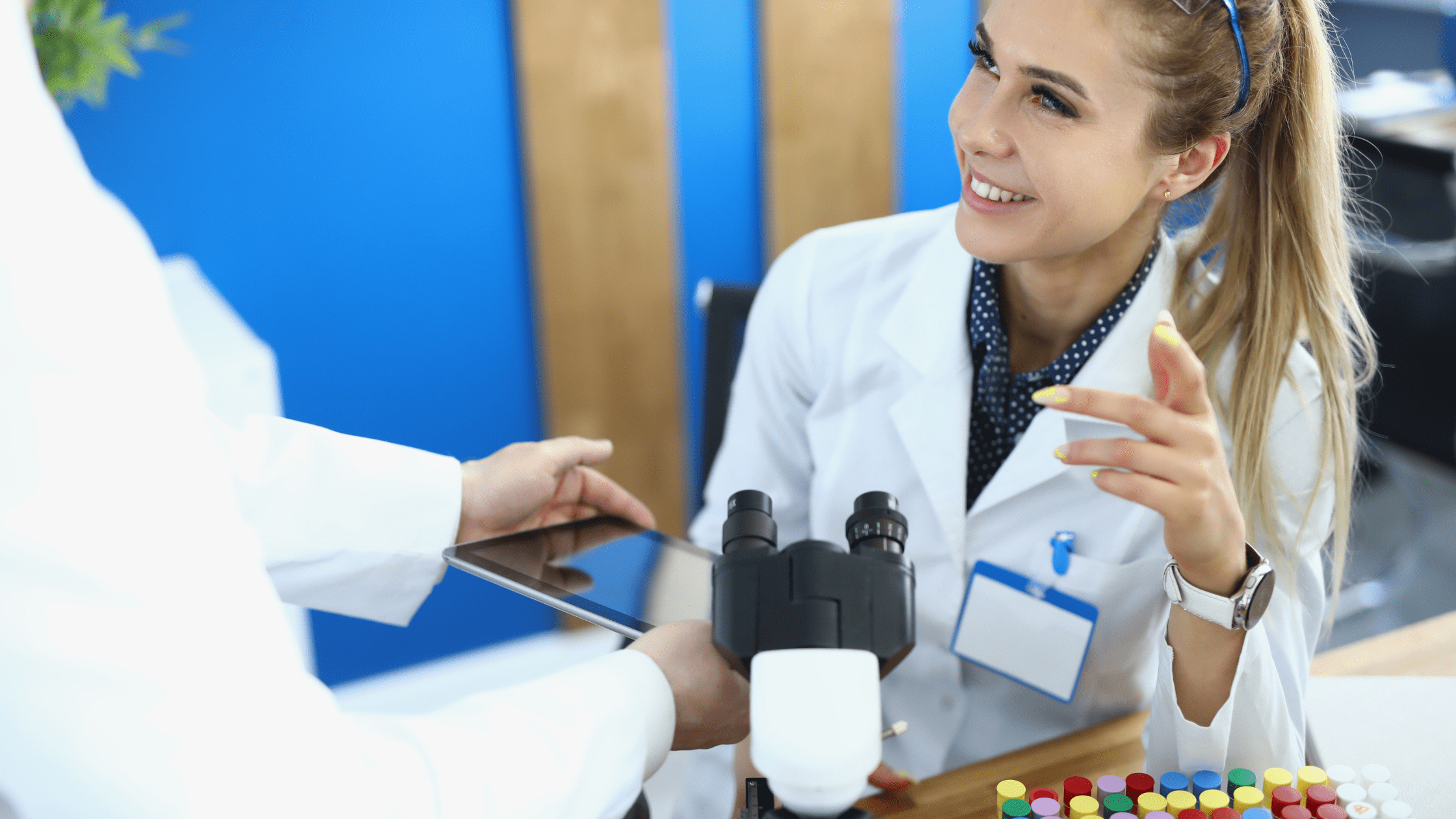 A Physician-Scientist sitting in front of a microscope.