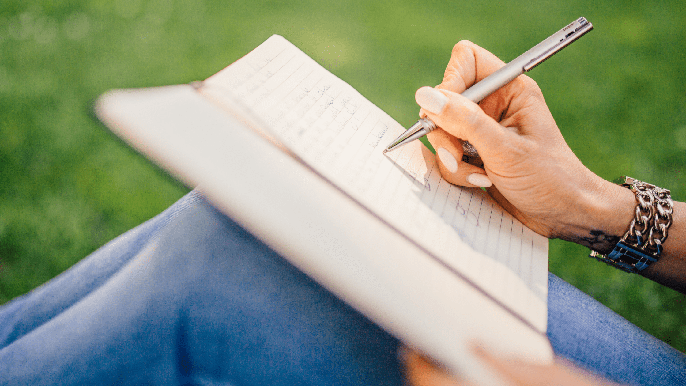 A student sitting and writing a medical school personal statement on her lap.