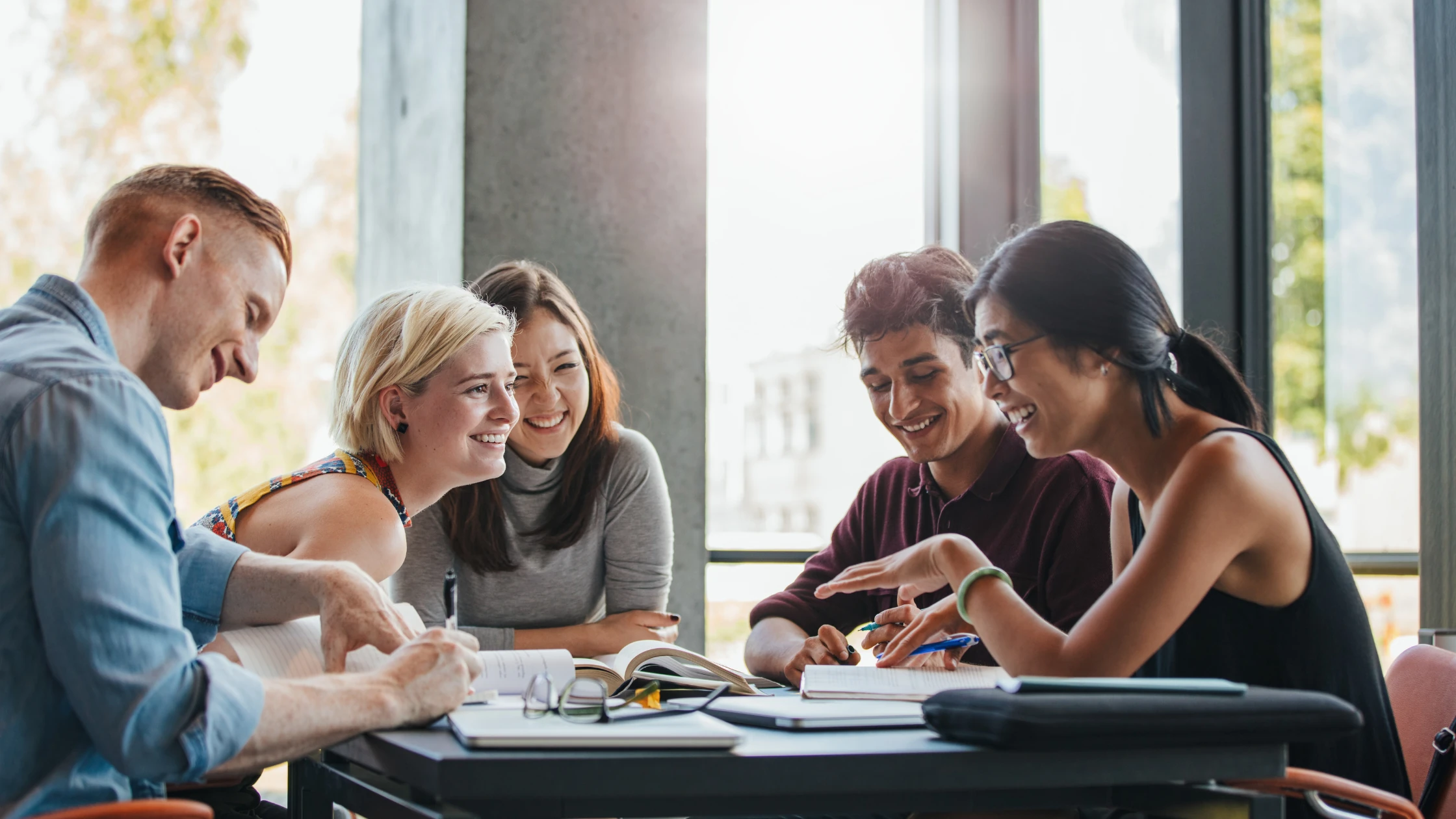 Group of medical students studying together and socializing, illustrating the balance between academic life and maintaining friendships.